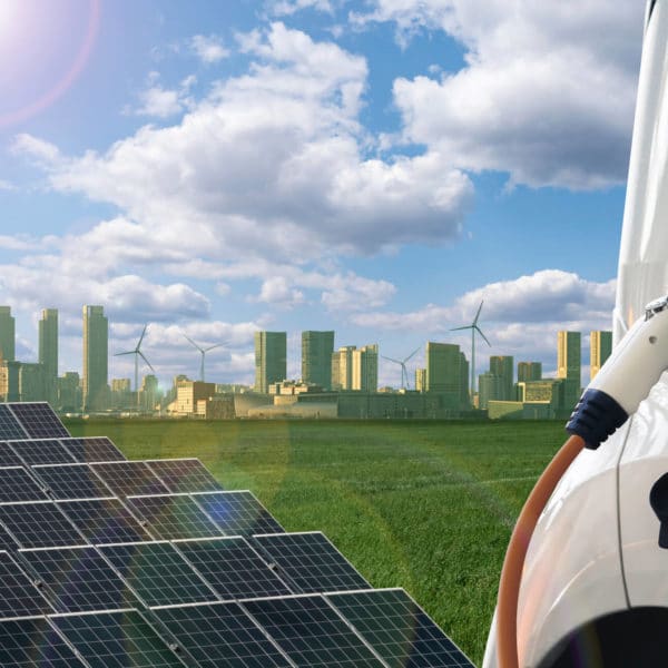 Picture of solar panels, el car and big city